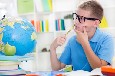 Little boy studying about the world,and thinkig something clipart