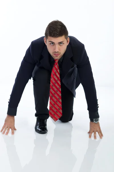 Businessman in a starting position, isolated on a white — Stock Photo, Image