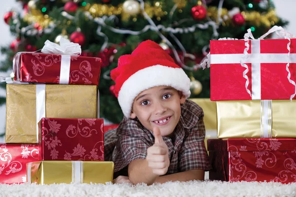 Happy little boy near a Christmas tree — Stock Photo, Image