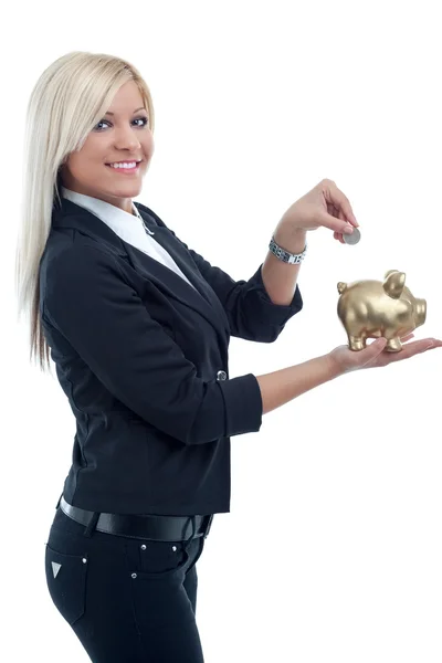 Jonge mooie vrouw een munt ingebruikneming een grote piggy bank — Stockfoto