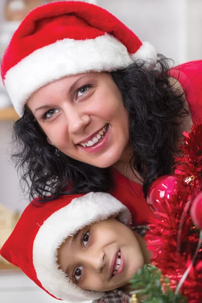 Happy mom and son next to the Christmas tree — Stock Photo, Image