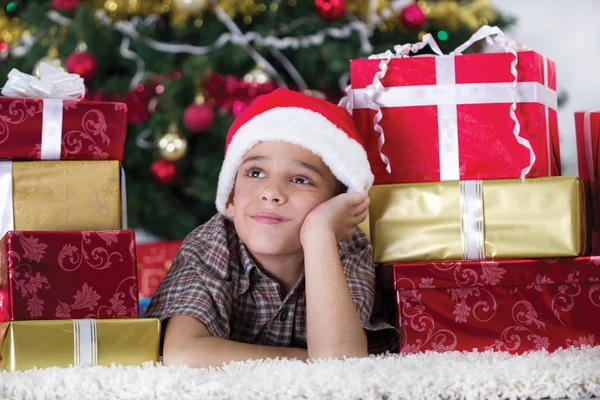 Criança na noite de Natal sonhando com presentes — Fotografia de Stock