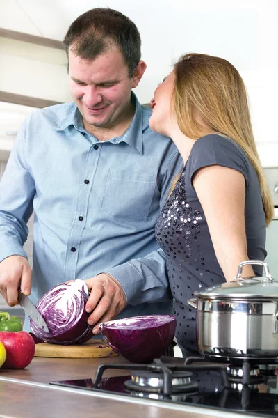 Happy couple in the kitchen preparing meals husband — Stock Photo, Image