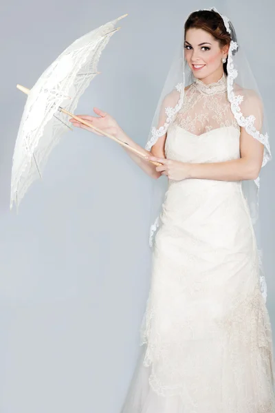 Beautiful elegant woman in a white wedding dress posing — Stock Photo, Image