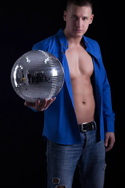 Молодой мускулистый мужчина держит диско-мяч — стоковое фото