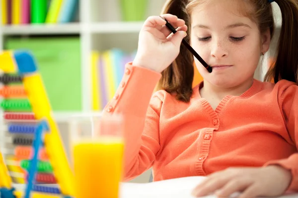 Cute little red-haired girl reading a book — Stock Photo, Image