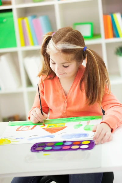 Red-haired girl with pigtails drawing with watercolors on the pa — Stock Photo, Image