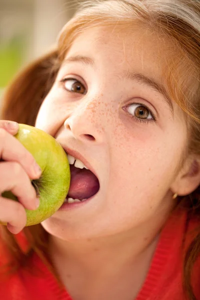 Cute little girl eating an apple Royalty Free Stock Images