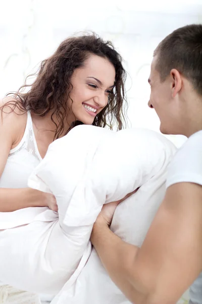 Couple fighting with pillows Stock Image