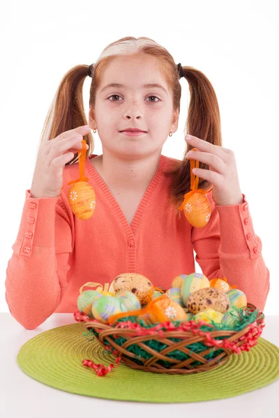 Beautiful little red-haired girl with pigtails holding Easter e — Stock Photo, Image