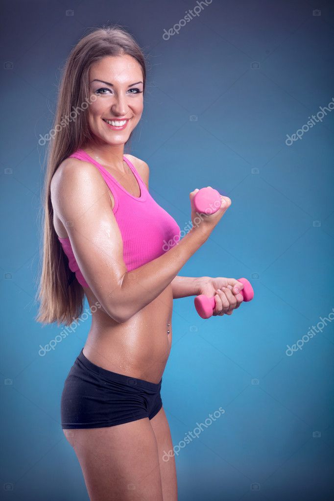 Attractive Fit Woman Works Out Dumbbells  Women fitness photography,  Fitness portrait, Fitness photos