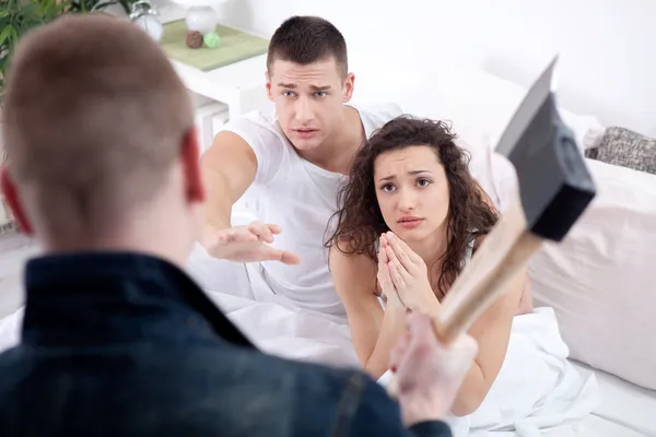 Angry husband with hatchet caught cheating wife with lover — Stock Photo, Image