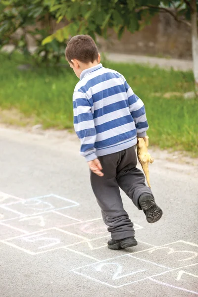 Boy on the hopscotch — Stock Photo, Image