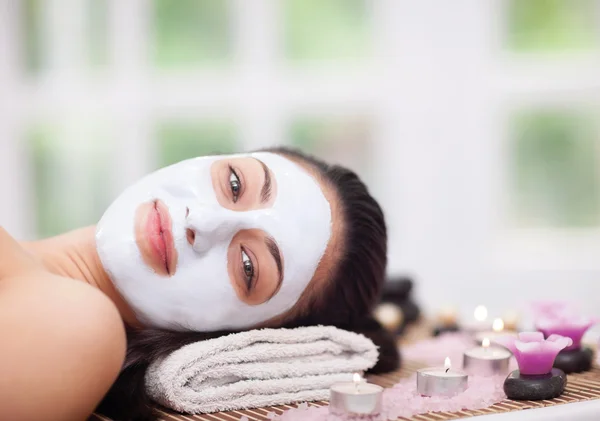 Spa therapy for young woman having facial mask at beauty salon Stock Photo