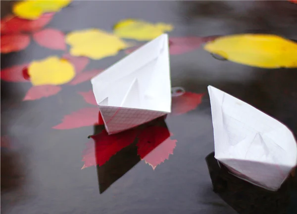 Autumn scene with paper boats