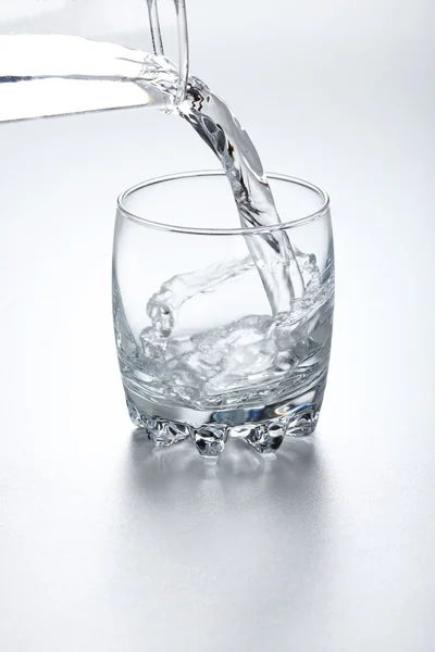 Water flowing into glass — Stock Photo, Image