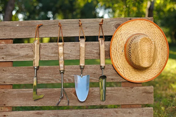 Garden tools on board fence — Stock Photo, Image