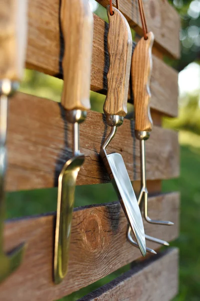 Garden tools on board fence — Stock Photo, Image