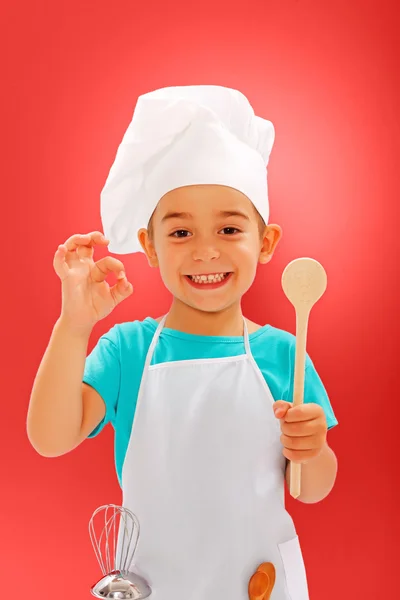 Cheerful little chef showing good taste — Stock Photo, Image