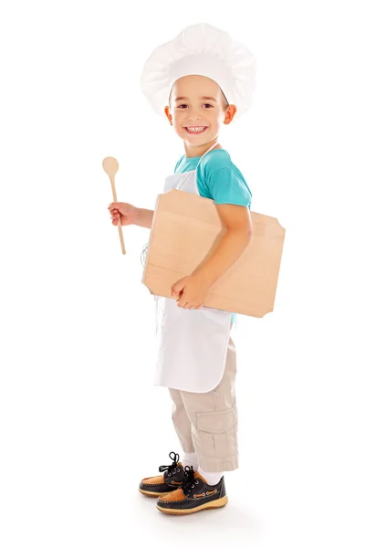 Happy little chef with wooden board and spoon — Stock Photo, Image