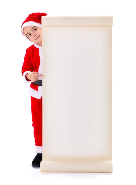 Chłopczyk Mikołaj, wskazując na duże listy życzeń — Zdjęcie stockowe