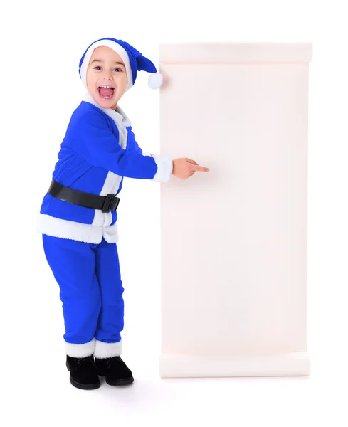 Little blue Santa Claus boy pointing at big wish list — Stock Photo, Image