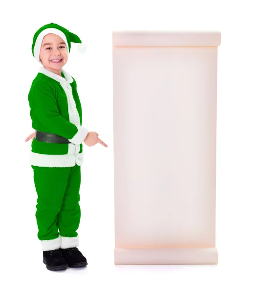 Little green Santa Claus boy pointing at big wish list — Stock Photo, Image