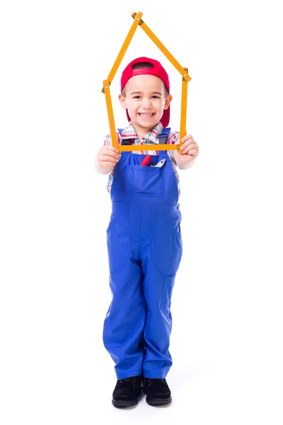 Boy showing house made of measuring ruler — Stock Photo, Image