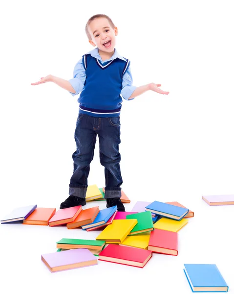 Kleine jongen met gevallen boeken — Stockfoto