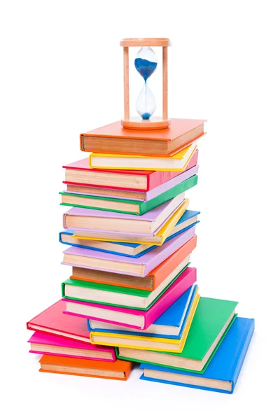 Stacked books and hourglass — Stock Photo, Image