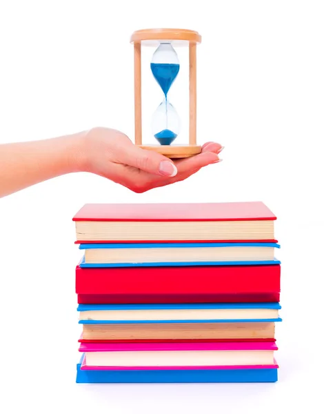 Stacked books and hourglass — Stock Photo, Image