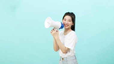 Portrait beautiful young woman smile with megaphone isolated over the blue background