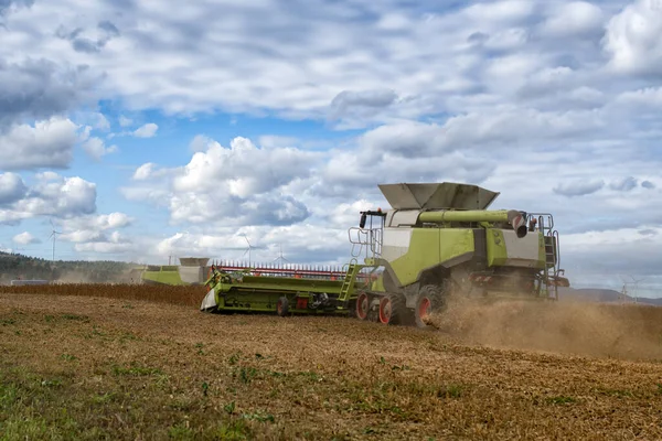 Combine harvester at work in soybean agricultural farm field