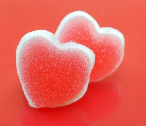 Sugar hearts on red background — Stock Photo, Image