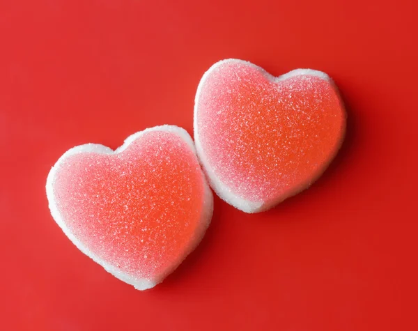 Sugar hearts on red background — Stock Photo, Image