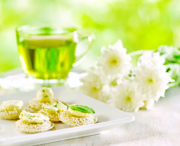 Mehrere Kanapees und eine Tasse Kräutertee. — Stockfoto