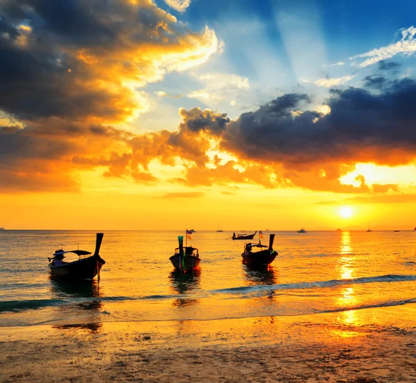 Traditional thai boats at sunset beach Royalty Free Stock Photos