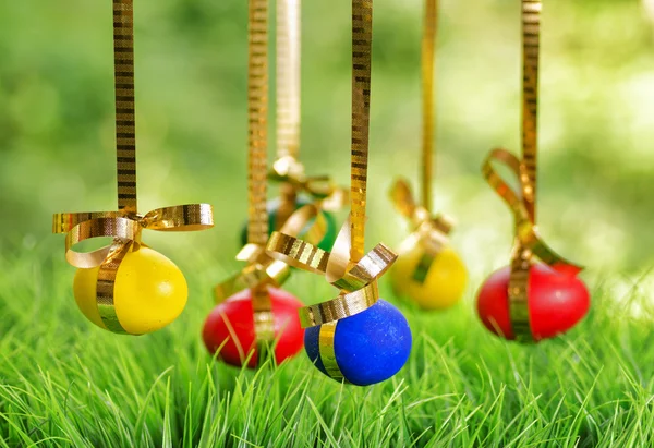 Velikonoční vejce visí na zlaté stuhy — Stock fotografie