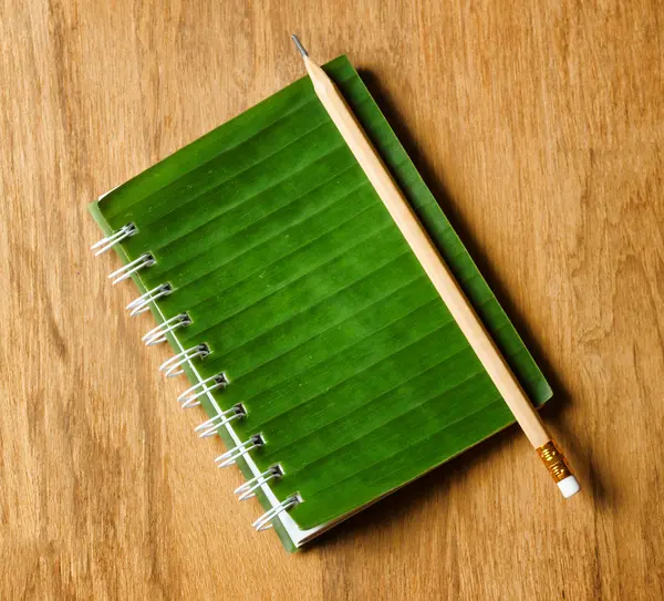 Notepad lies on wooden board — Stock Photo, Image