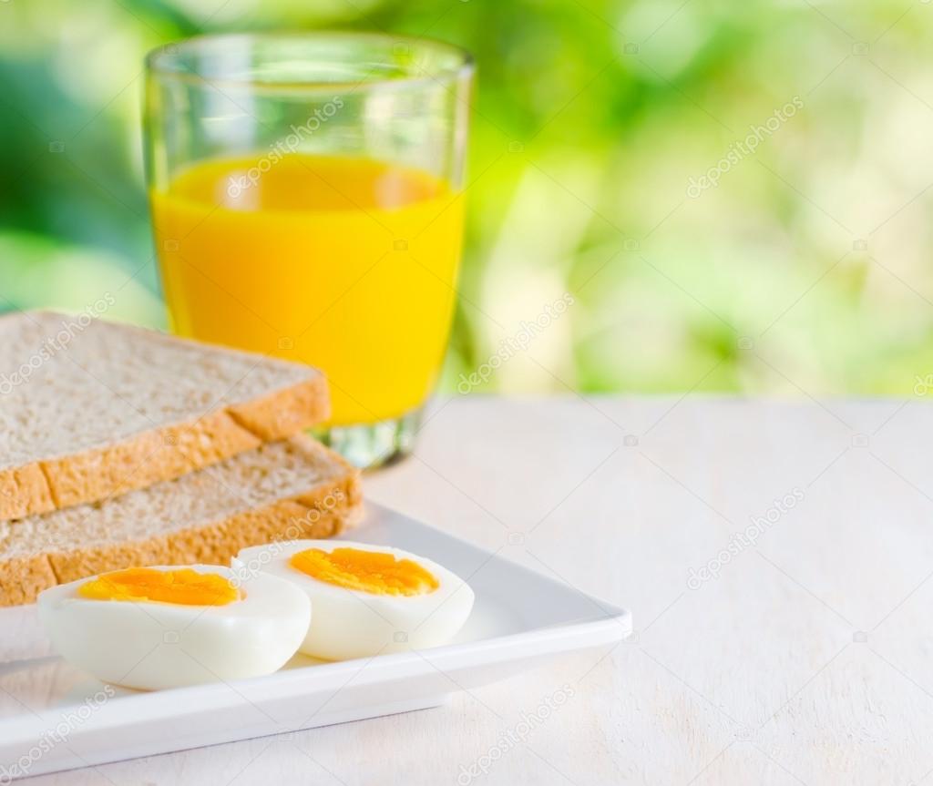 Boiled egg, toasts and orange juice.