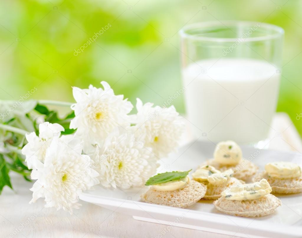 Several canapes and glass of milk