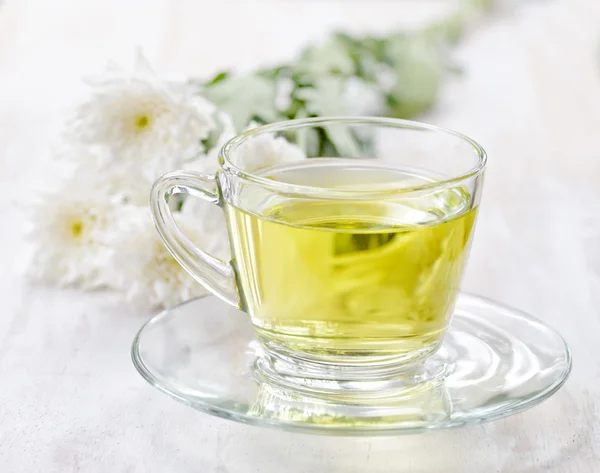 Cup of herbal tea and flowers — Stock Photo, Image