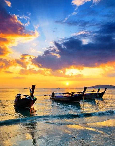 Traditional thai boats at sunset beach Stock Photo
