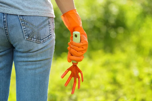Žena v oranžové rukavice, pracuje na zahradě — Stock fotografie