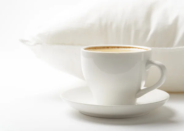 Cup of coffee and white pillow — Stock Photo, Image