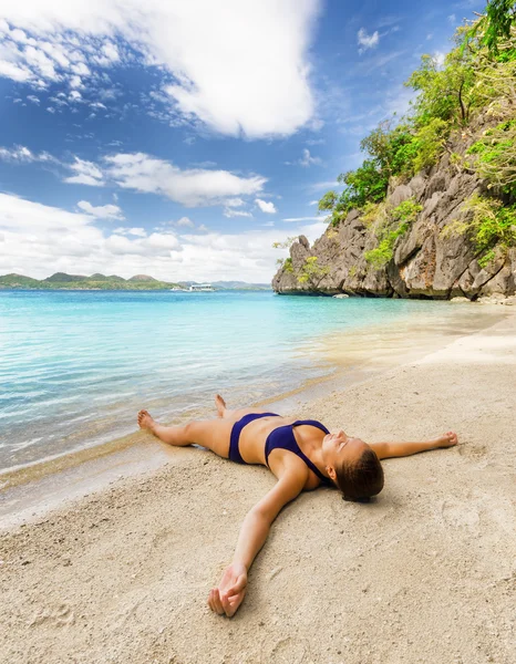 Mladá krásná žena je relaxační na písku u moře — Stock fotografie