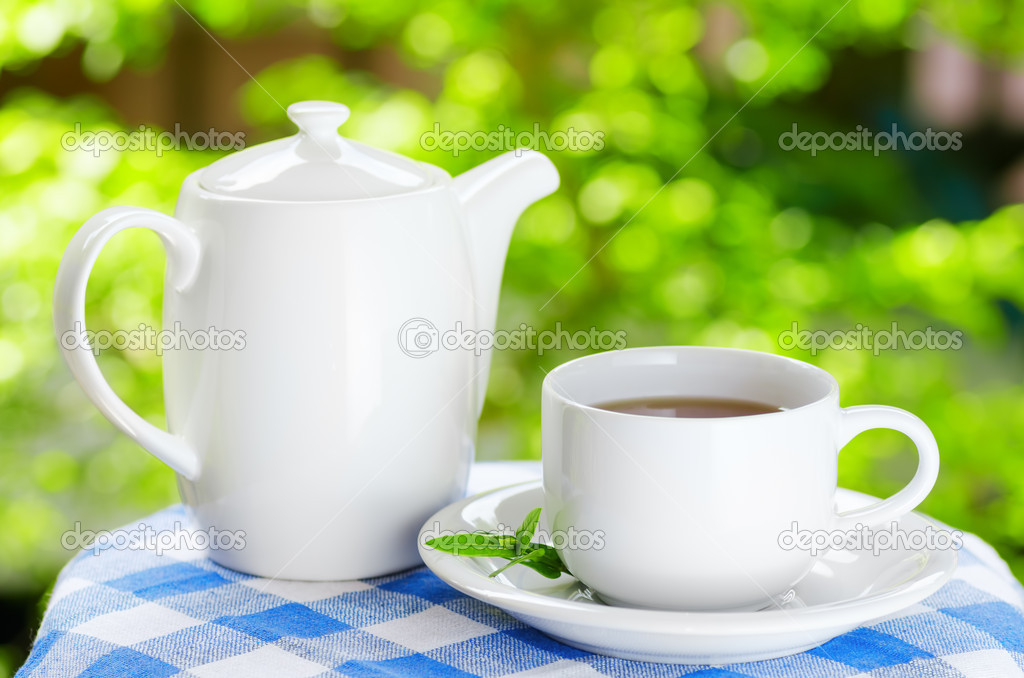 Cup of tea on nature background