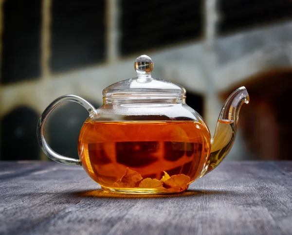 Teapot of fresh tea on wooden table — Stock Photo, Image