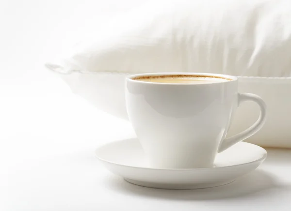 Cup of coffee and white pillow — Stock Photo, Image