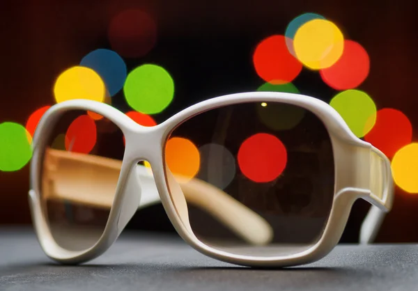 Weiße Sonnenbrille aus Plastik. Lustiges Bokeh — Stockfoto